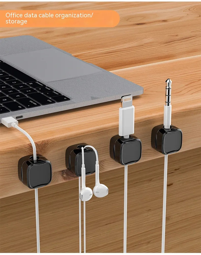 Black magnetic cable clips holding desk cables
